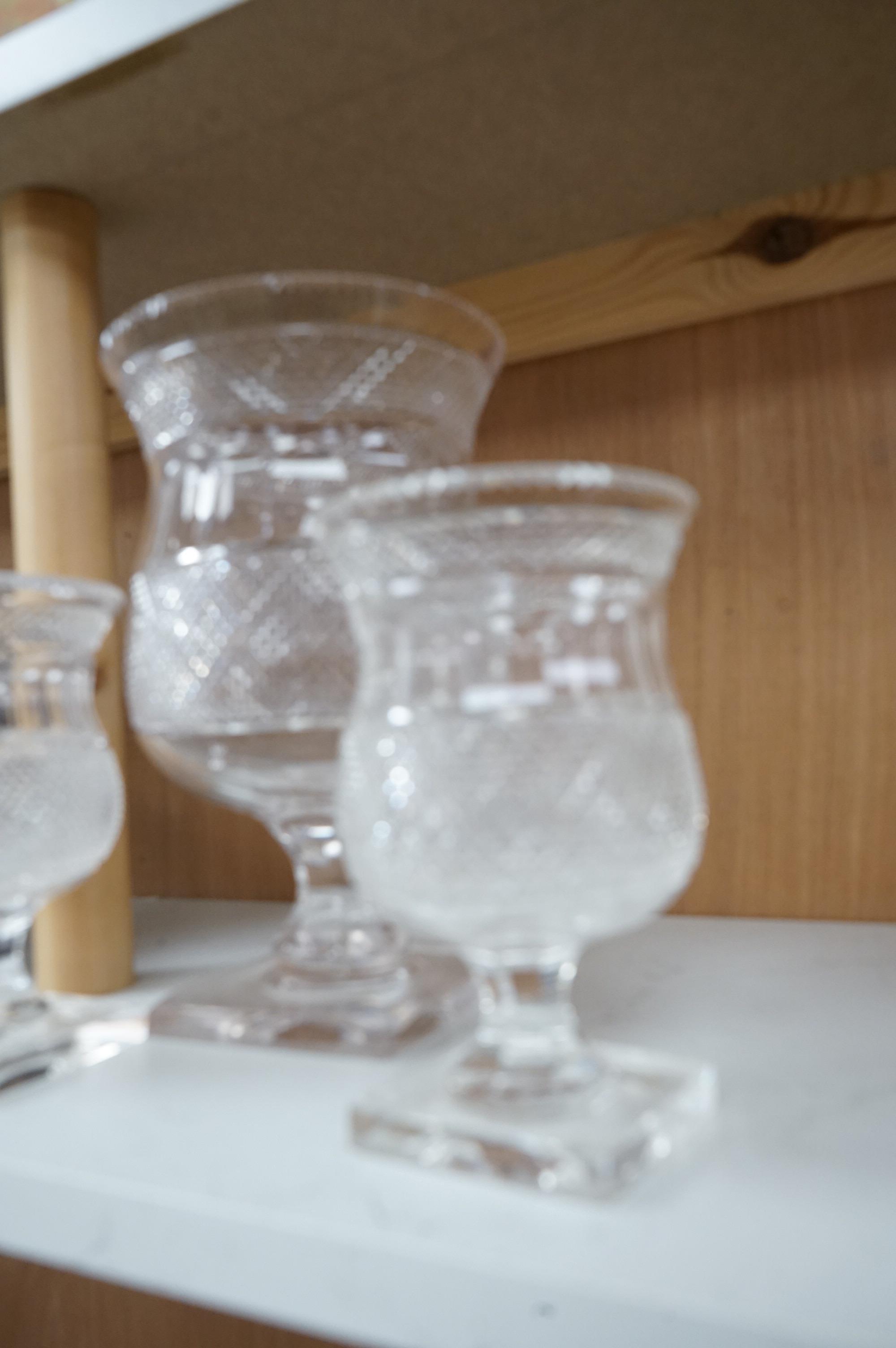 A garniture of three 19th century cut glass vases, largest 26cm high